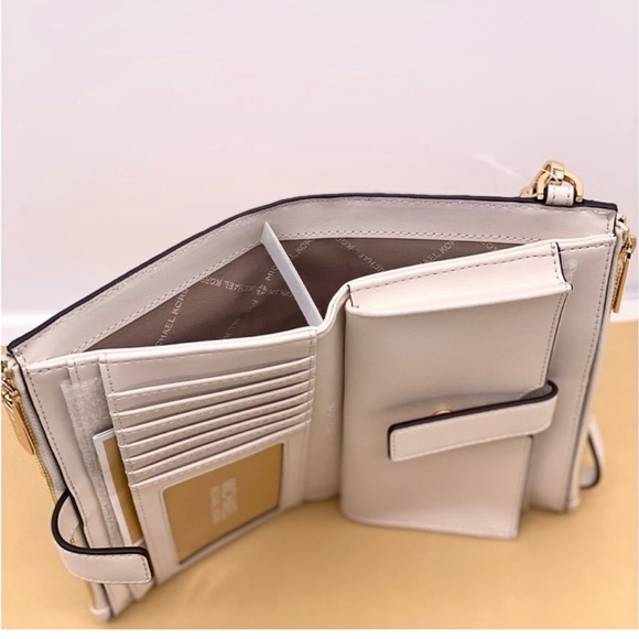 MICHAEL KORS LG DOUBLE ZIP
WRISTLET WALLET PHONE
HOLDER LIGHT CREAM MULTI - Picture 12 of 12